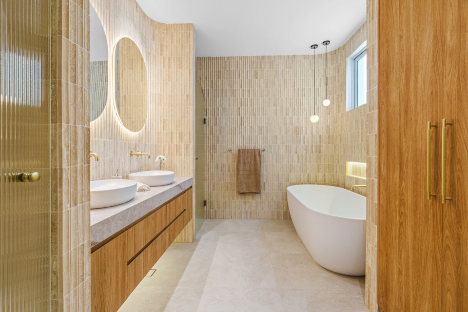 Illustration: a finished bathroom with a freestanding bath and timber vanity.